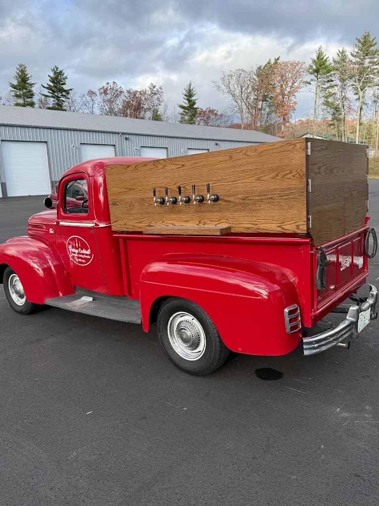 Vintage red Ford tap truck with draft beer taps at outdoor event