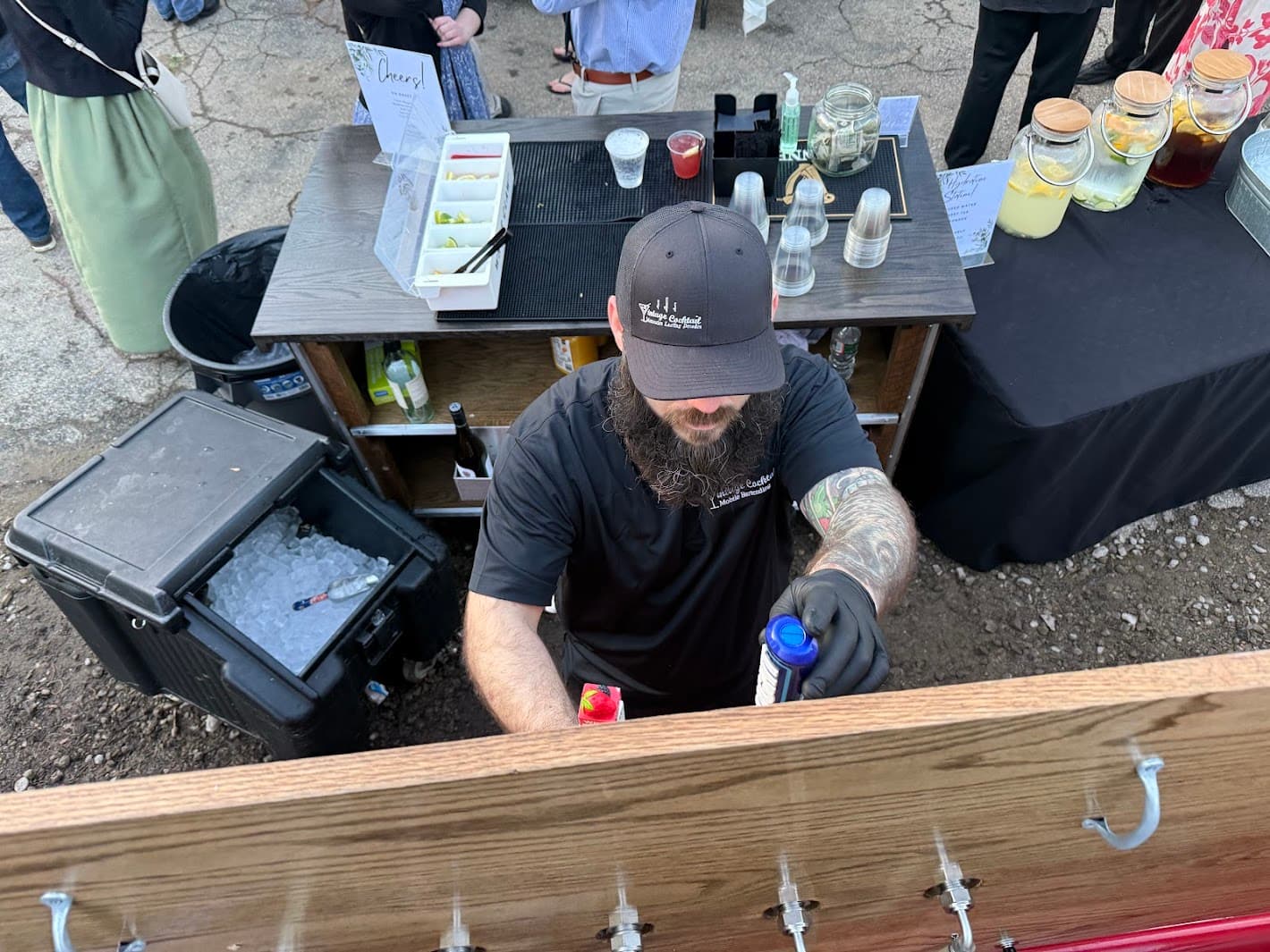 Bartender preparing drinks and managing the bar during busy event