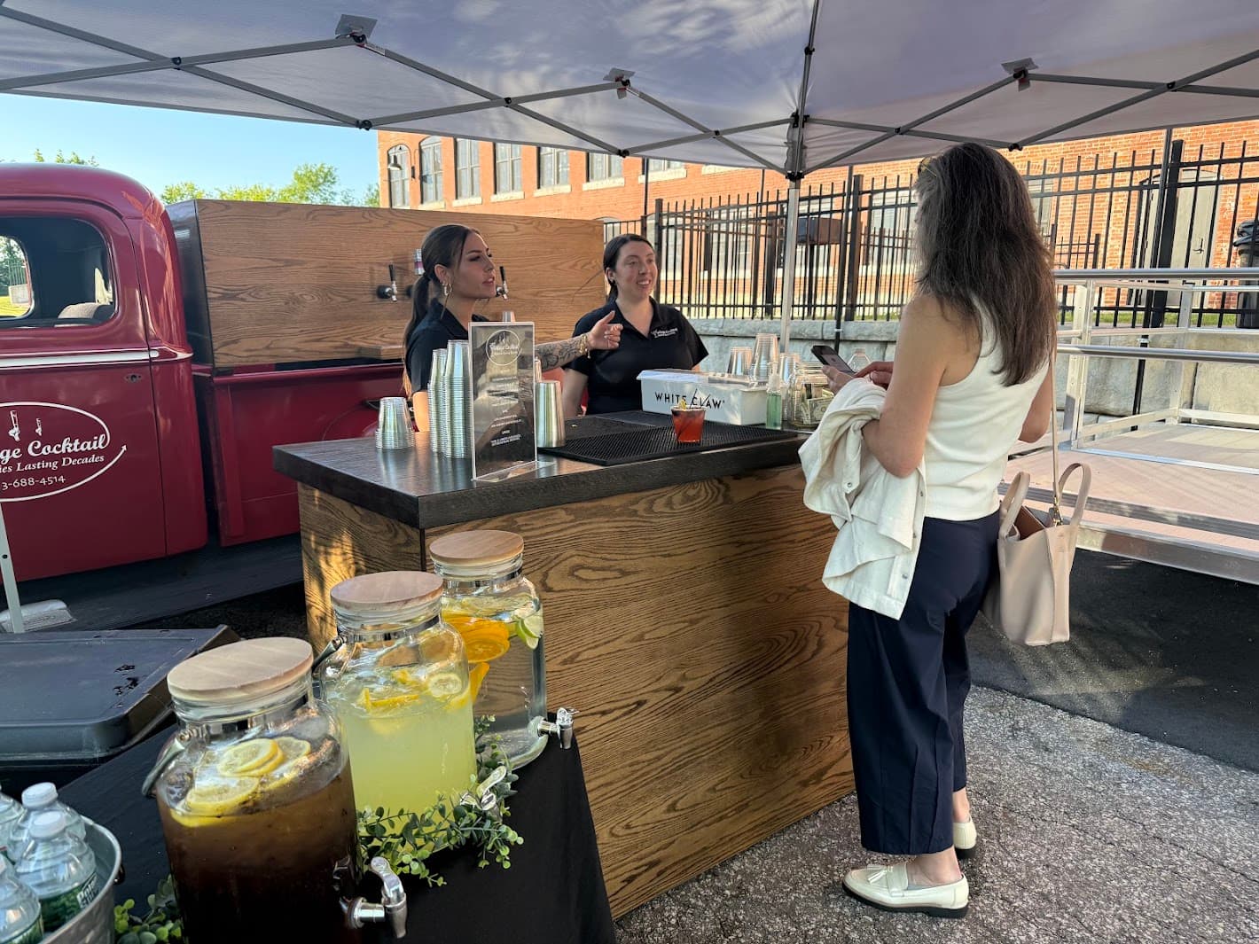 Staff members engaging with guests at the mobile bar counter during event