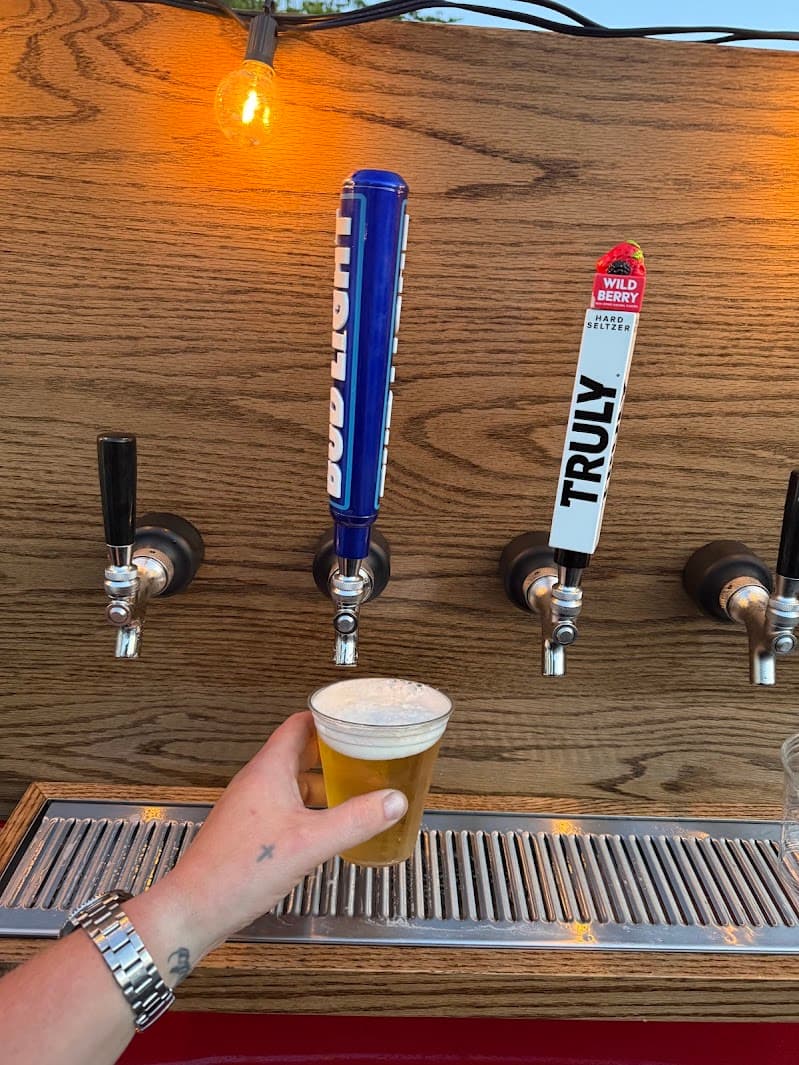 Close-up of bartender pouring a fresh beer from tap for guest