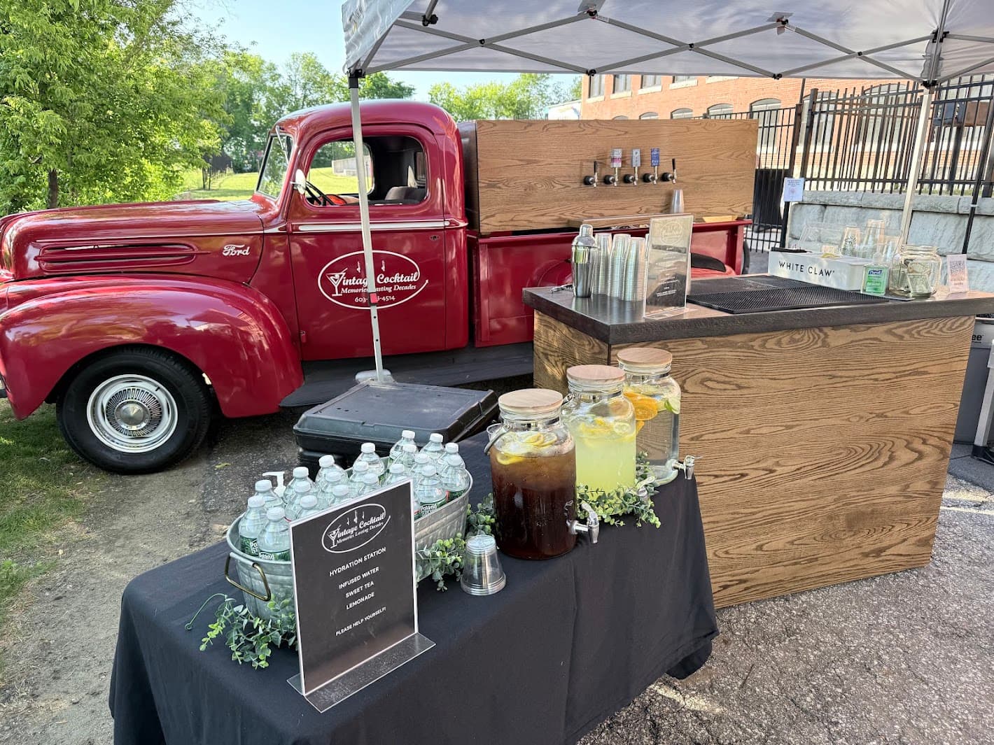 Complete bar setup with tap truck, beverage dispensers and display table