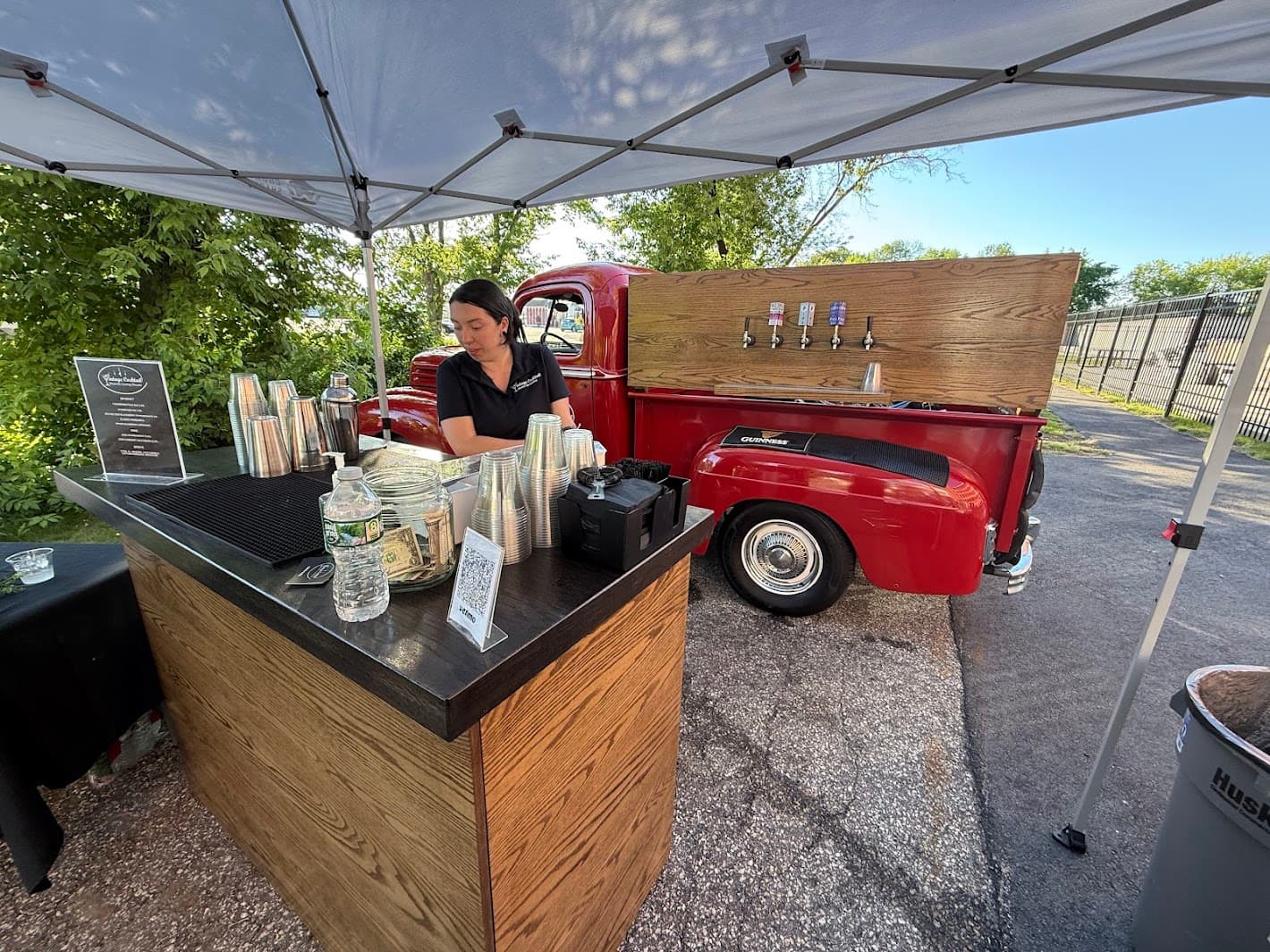 Bartender pouring beverages at the counter with organized tap system