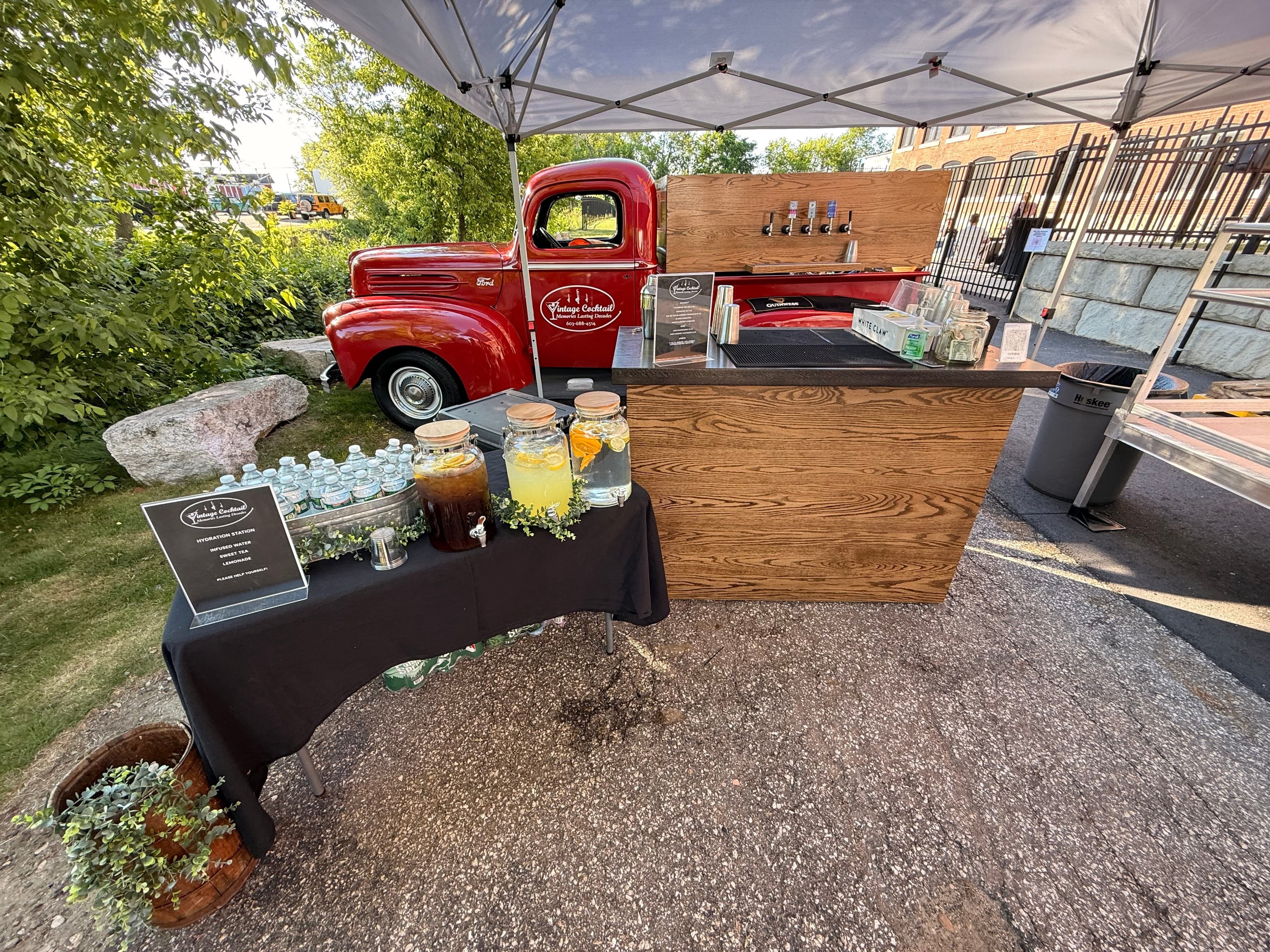 Vintage red cocktail truck at event with beverages and bar setup - Mobile bar service in New Hampshire
