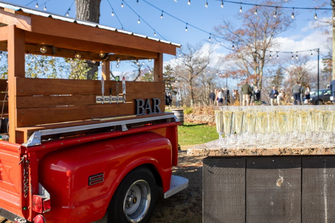 1968 Chevy tap trailer with BAR sign and champagne glasses at outdoor event