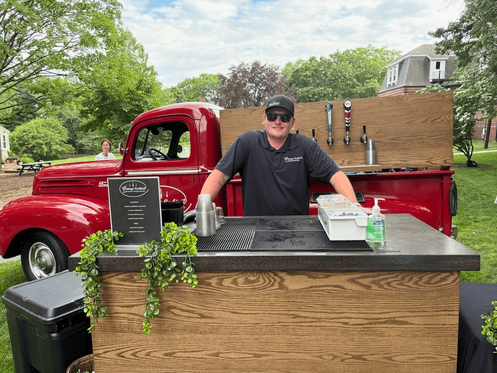Vintage red Ford tap truck with bartender at service counter