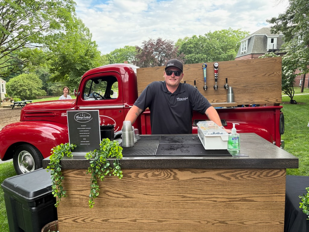 Vintage red Ford tap truck with bartender at service counter