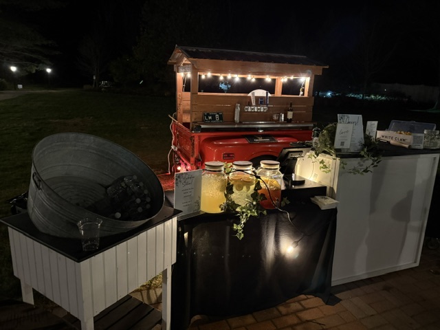 1968 Chevy tap trailer with full bar setup at nighttime outdoor wedding